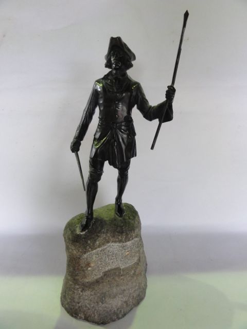 A good quality bronze study of an 18th century mariner clutching a sword in his right hand and