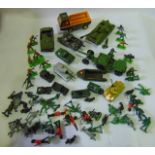 A box containing a selection of military related model vehicles and effects to include a Dinky