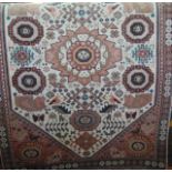 A small woven wool rug with cream ground decorated with geometric medallion and further geometric