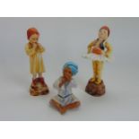 A collection of three Royal Worcester figures representing children of the world and modelled by F G