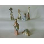 A collection of Lladro figure groups including a model of Don Quixote, a girl holding a wide brimmed