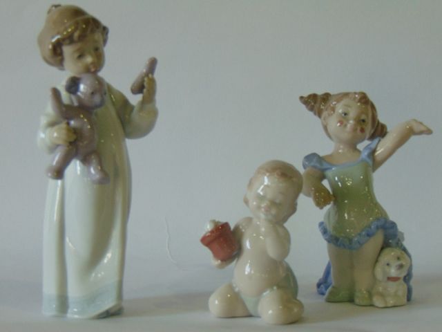 A collection of three Nao figures comprising Poor Teddy, Grand Finale and Petals and Hugs (all