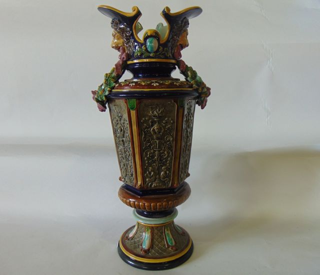 A substantial 19th century continental majolica vase with shaped neck, moulded lions mask and leaf