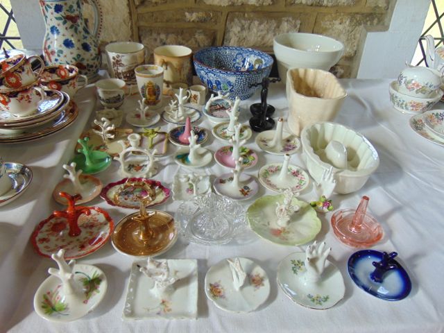 A collection of ceramic and other ring stands of various designs including floral decorated