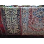 A brick ground wall rug with complicated medallion detail and further decoration depicting