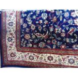 A good quality fringed rug with deep blue ground and central foliate medallion detail in shades of