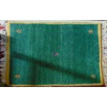 A small wool rug with deep green field with simple detail set within a yellow border, 105 x 60 cm