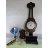 An oak cased wall hanging wheel barometer with silvered dials, a turned treen vessel of