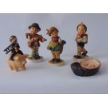 A collection of Goebel Hummel figures including a boy sweep holding a ladder and a clock riding on