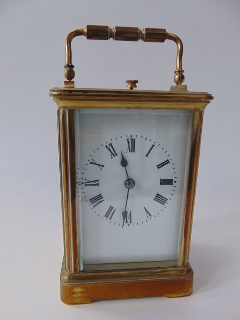 A good quality brass cased carriage clock with bevelled glazed panelled sides and front revealing