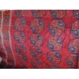 A substantial good quality carpet in the Persian manner with a deep red ground decorated with