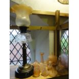 An oil lamp raised on a brass fluted column supporting a clear cut glass fount with a Duplex burner,