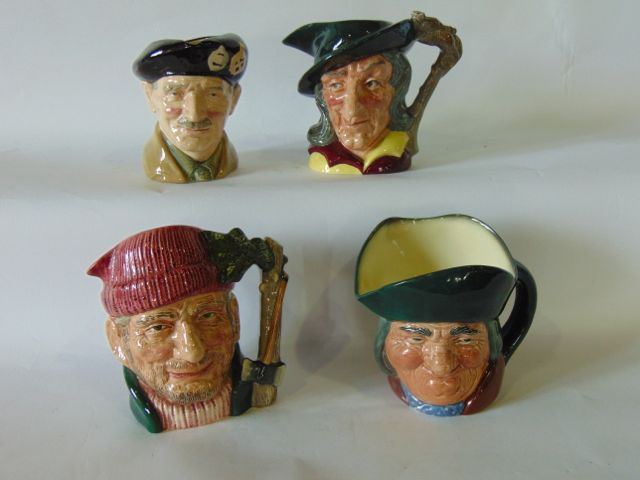 A collection of four large Royal Doulton Character Jugs - Lumber Jack D6610, Monty D6202, Pied Piper