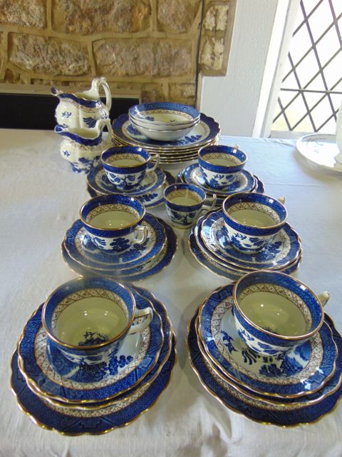 A collection of Booths Real Old Willow pattern blue and white painted dinner and tea wares including