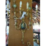 A single cast brass two branch wall light in the classical style with ribbon,  garland and