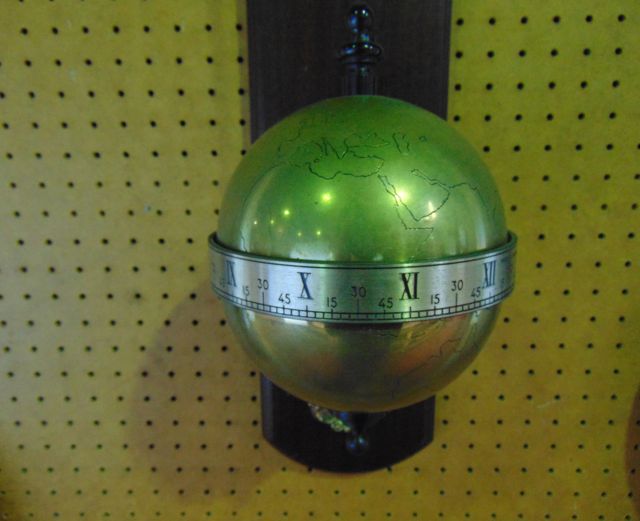 A falling ball wall mounted clock by Thwaites & Reed dated 1972 in the form of a brass globe with - Image 2 of 2