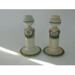 A matched pair of Wedgwood Tri-colour candlesticks in the classical manner with pink and green swag,