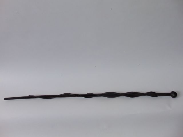 A carved hardwood cane decorated with three coiling snakes with incised snake detail and inset