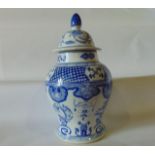 A large oriental vase and cover with blue and white painted decoration incorporating dragons,