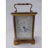 A brass framed French carriage clock with bevelled glazed panelled sides, the movement stamped 9