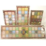 A collection of 19th century leaded coloured glass panels with geometric designs in blue, red,