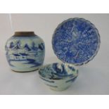 A collection of oriental blue and white ceramics comprising a ginger jar with landscape