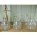 A collection of four moulded glass wasp traps with moulded wasp detail together with a tall glass