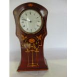 A late 19th/early 20th century mantle clock of shaped and tapering pillar box form, the mahogany