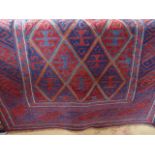 A coarsely woven wool rug with multi kite shaped medallion centre in shades of deep blue and red,
