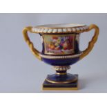 A Royal Worcester two handled urn shaped vase with finely painted panel to the front showing a still