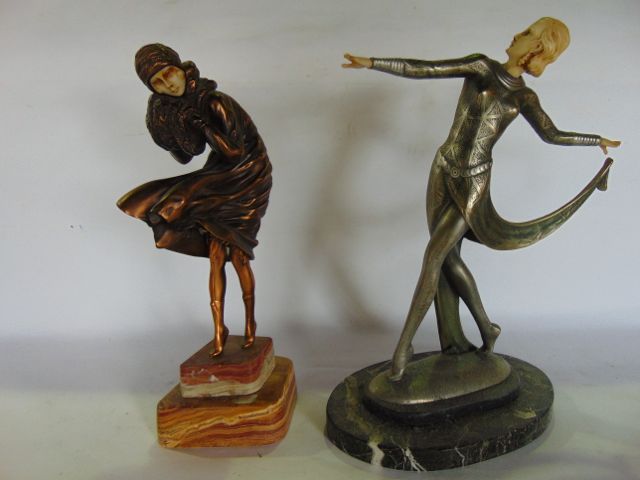 A figure of an elegant standing female in the Art Deco manner, with patina type finish and ivorine