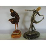 A figure of an elegant standing female in the Art Deco manner, with patina type finish and ivorine