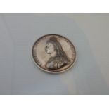 A heavy white metal Victorian commemorative medal with relief profile portrait of The Queen to one