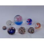 A collection of glass paperweights including Strathearn examples, one with faceted detail and
