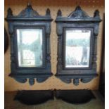 A pair of Victorian heavy cast iron framed wall mirrors enclosed in rectangular bevelled glass