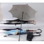 A selection of ladies vintage and earlier parasols to include an example with polished bamboo stem