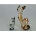 Two Swarovski models of siamese cats, one in an amber colourway the other in a grey colourway,