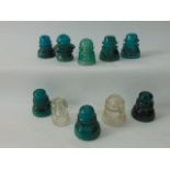 An interesting collection of late 19th/early 20th century green glass insulators including