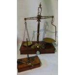 A substantial Victorian set of brass framed beam scales with pierced framework raised on a