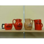 Three red ground Carlton ware jugs inscribed Haig Scotch whisky together with a further Carlton ware