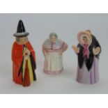 A collection of three Royal Worcester candle snuffers in the form of a witch in orange cloak, number