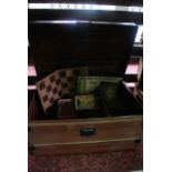 A substantial Victorian tin trunk with domed top and hinged lid, with brown painted finish and