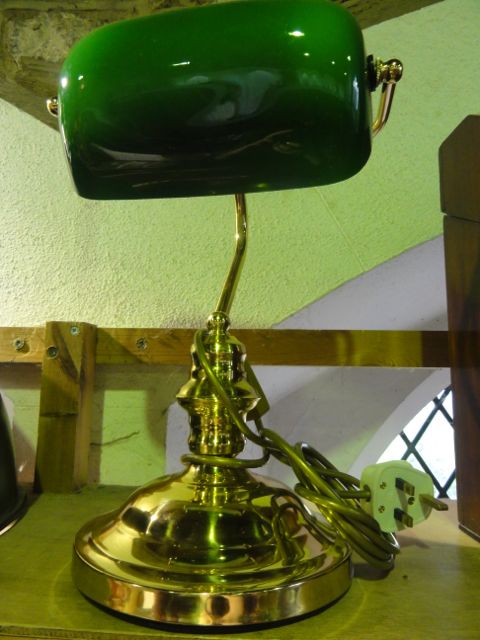 A reproduction desk lamp, principally in brass with an opaque lined green glass shade of rectangular