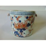 A 19th century two handled Imari jardinière of cylindrical form with fluted moulding and painted and