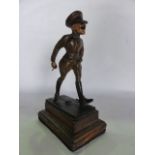 A 20th century cast metal figure of a humorous character in military costume, with painted finish
