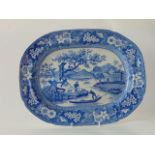 An early 19th century blue and white printed meat plate of oval form with central panel showing