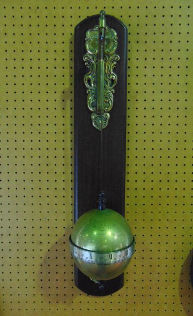 A falling ball wall mounted clock by Thwaites & Reed dated 1972 in the form of a brass globe with