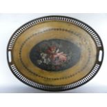 A decorative metal tray of oval form painted with a floral still life upon a dark ground to centre,