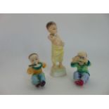 A set of three Royal Worcester figures by F G Doughty representing children of the world and
