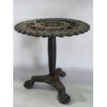 A heavy antique cast iron trivet/stand, the circular top with extensive pierced detail raised on a